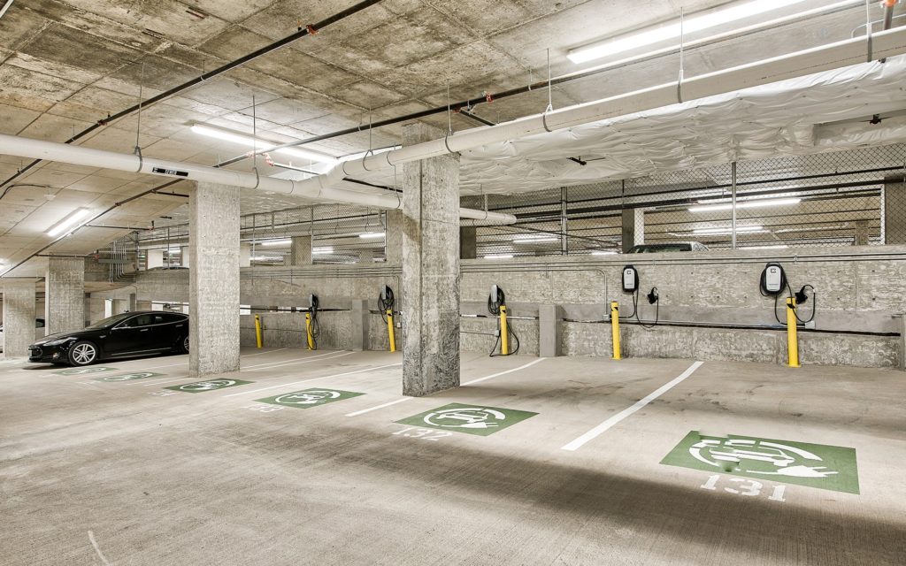 Parking garage with designated electric vehicle parking spots