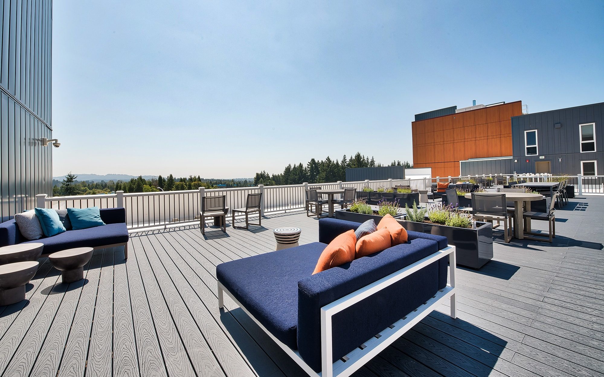 Rooftop amenity space with lounge seating and tables