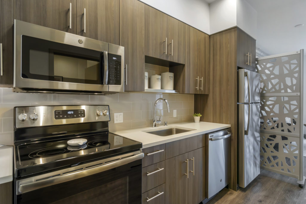 Kitchen with stainless steel appliances and tile backsplash